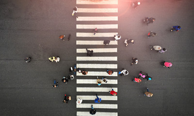 Urban lifestyle. People crowd on pedestrian crosswalk. Zebra crossing, top view.