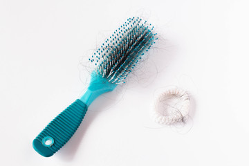 Girl Hairs fall with a comb and problem hair on white background. Hair fall or loss with blush is a problem of women.
