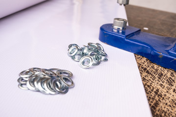 Close up hand press eyelet machine and eyelets details © ozencdeniz