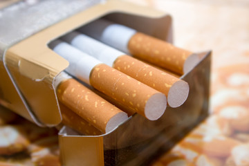 Cigarettes in a pack with a yellow filter