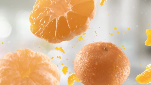 Tangerine with Slices Falling on Kitchen Background