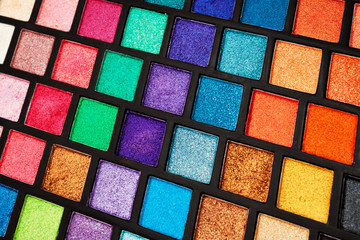 palette of multi-colored eyeshadow closeup. Background for design
