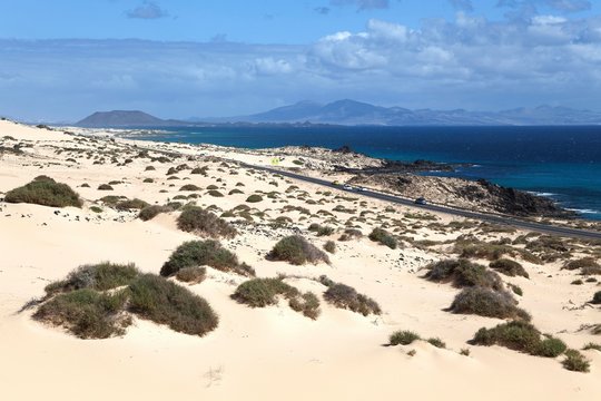 Road FV 1 in the wandering dunes El Jable, Las Dunas de Corralejo, Corralejo Natural Park, behind the island of Los Lobos and Lanzarote, Fuerteventura, Canary Islands, Spain, Europe
