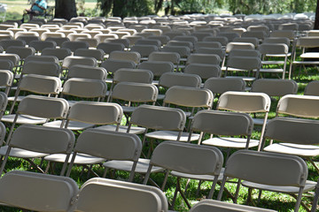 Multiple rows of empty white chairs