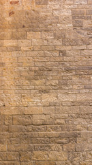 Background of old stone wall. The texture of the stone surface. Brickwork in the old European city. Pattern in retro style
