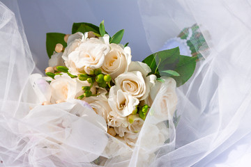 Exquisite wedding bouquet of white flowers: freesia, orchids and roses.