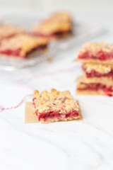Freshly Baked Strawberry Bar Cookies, Some Cooling on Wire Rack with some isolated in front on white countertop