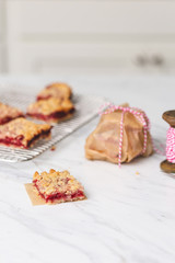 Freshly Baked Strawberry Bar Cookies, Some Cooling on Wire Rack with some isolated in front on white countertop