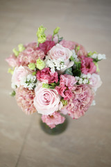 Delicate wedding bouquet in pink tones of roses and lisianthus.