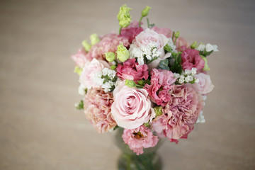 Delicate wedding bouquet in pink tones of roses and lisianthus.