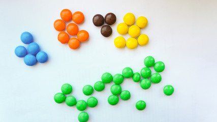 colorful chocolate buttons on a white background