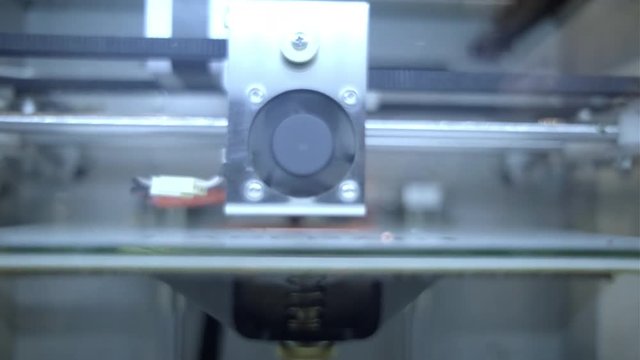 3D diy printer printing plastic mechanical parts in timelapse.An open source diy 3d printer is printing gears and pulleys,using disposable biodegreadable PLA material (filament)