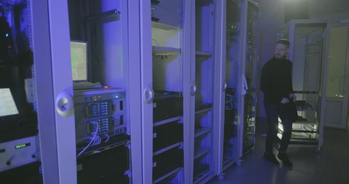 Hacker enters server room and starts to type code