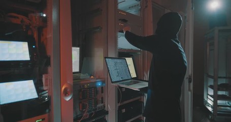 hacker in mask cracks the system in data centre