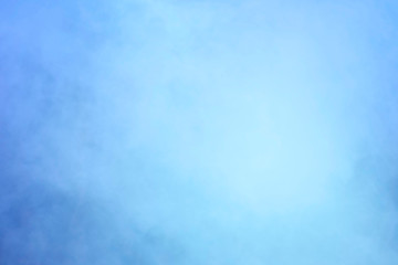 Abstraction. Background or texture in blue and light blue tones. Blurred image. Smoke-filled space.