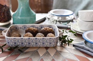 Traditional Russian cake with cocoa in the shape of a ball. Served breakfast table with mugs of tea and dessert.