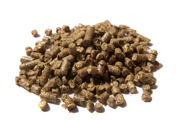 Light brown pressed solid wooden pellets granules on white background