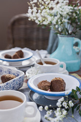 Traditional Russian cake with cocoa in the shape of a ball. Served breakfast table. Reflection of light in a mug of tea. Cozy morning at home.