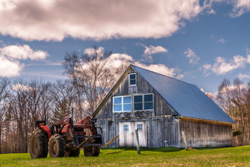 Old barn and tractor on a farm © Skyler