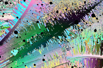 Colorful micro crystals in polarized light. Photo through a microscope.