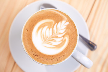 cup of cappuccino on the wooden background