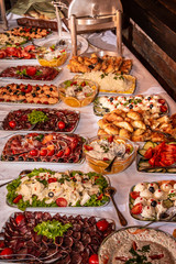 Buffet table with cold snacks and delicious appetizers. Catering food event banquet table.