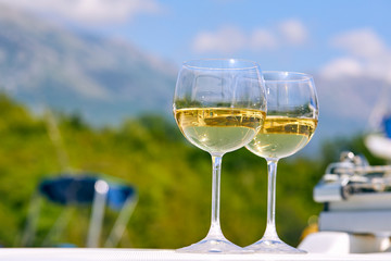 Pair of wineglasses against the yacht