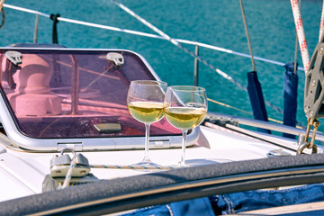 Pair of wineglasses against the yacht