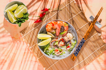 Noodles with prawns and clams, seafood asian spicy bowl.