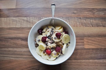 healthy breakfast with fresh fruits and oats on a wooden table