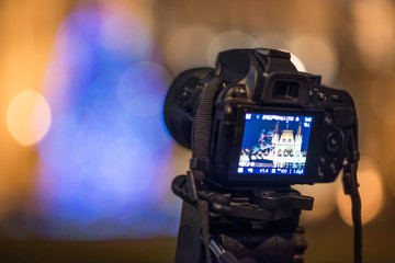 DSLR Camera on tripod capturing architecture with bokeh background