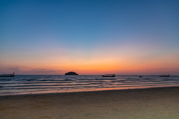 Fototapeta premium Beautiful sunset with the silhouette of a island and boat in Otres, Cambodia.