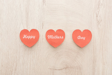 top view of red paper cards with happy mothers day writing on wooden table