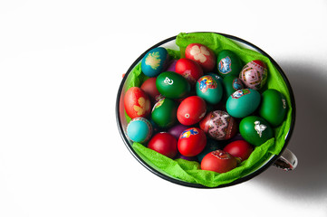 Painted eggs in a bowl isolated on a white background