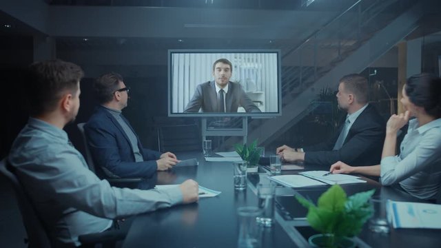 In the Conference Room Group of Directors, Investors and Businessmen Making Late Night Video Conference Call To Talk with International Corporation Representative