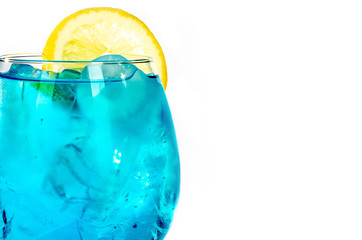 blue drink with ice cubes and lemon on white background, isolated