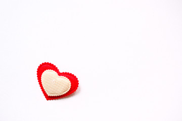 red and white heart made of fabric on white background
