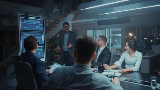 In the Corporate Meeting Room: Energetic and Confident Young Startup Inventor Uses Digital Interactive Whiteboard for Presentation and Delivers Speech to a Board of Investors and Businesspeople
