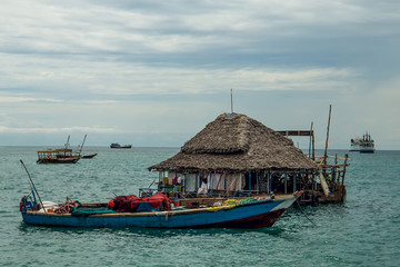Obraz premium houseboat and small boats near the ocean