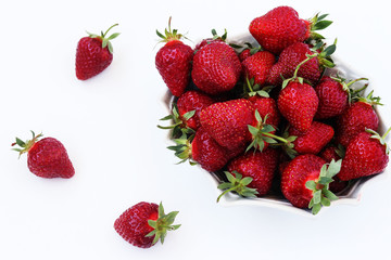 Fresh strawberries in a plate on a white background