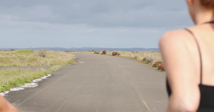 Twp women running together on country road
