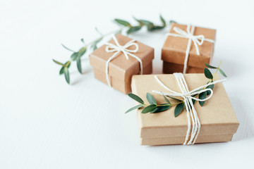 Craft gift boxes on white wooden background. Copy space for text. Eco concept