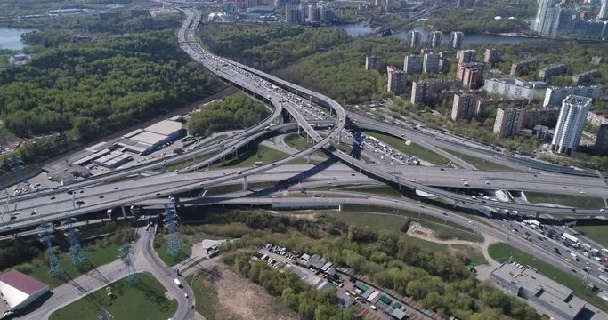 Aerial top view of road junction and  transport traffic with vehicle movement by drone. Drone video of Moscow  junction road at day time. Dmitrovskoe shosse, Russia.