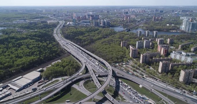 Aerial top view of road junction and  transport traffic with vehicle movement by drone. Drone video of Moscow  junction road at day time. Dmitrovskoe shosse, Russia.