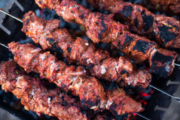 roasted meat, skewers with onions on skewers on the grill