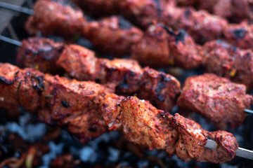 roasted meat, skewers with onions on skewers on the grill