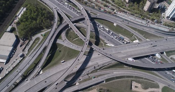 Aerial top view of road junction and  transport traffic with vehicle movement by drone. Drone video of Moscow  junction road at day time. Dmitrovskoe shosse, Russia.