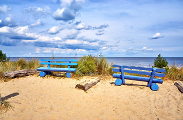 Two blue benches on the cliff in Ückeritz on the beach. Baltic Sea in Mecklenburg-Vorpommern, Germany.