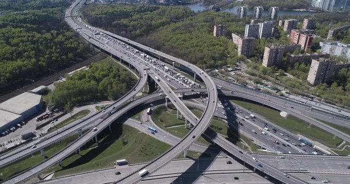 Aerial top view of road junction and  transport traffic with vehicle movement by drone. Drone video of Moscow  junction road at day time. Dmitrovskoe shosse, Russia.