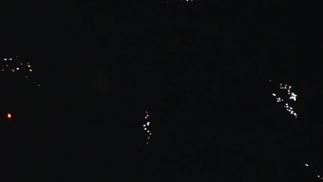 Fireworks Exploding in Night Sky PAN RIGHT SLOW MOTION